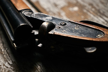 Hunting shotgun riffle on old rustic wooden table - obrazy, fototapety, plakaty
