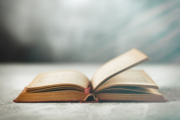 Open book on grey table