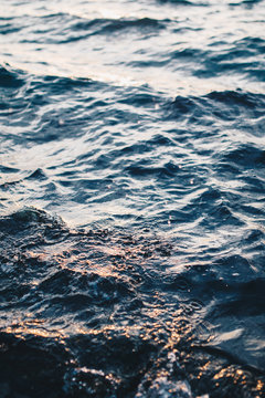 Close up of sea water. Sun reflecting in the water.