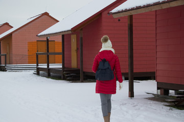 Traveler woman is walking through a campsite in winter season.