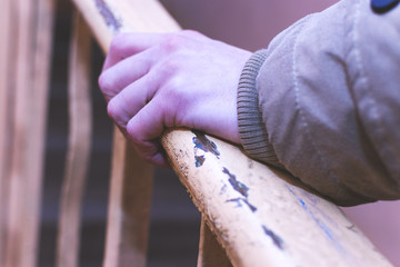 The man holding his hand over the railing
