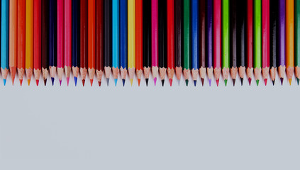Assortment of coloured pencils with shadow on white background.