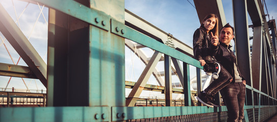 Father and daughter resting on the freight bridge