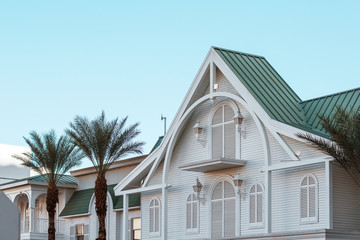 Beautiful white wooden house with palm trees