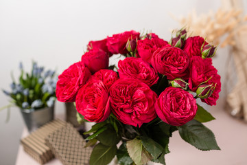 Red garden rose. Bouquet flowers of roses in glass vase. Shabby chic home decor.