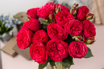 Red garden rose. Bouquet flowers of roses in glass vase. Shabby chic home decor.