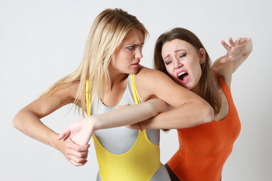two gymnastic women wrestling