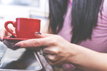 Girl drinking coffee in front of the computer. Interval.