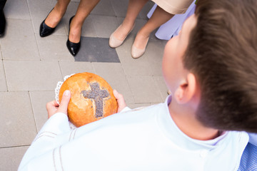 The First Holy Communion - handing over the devoted bread