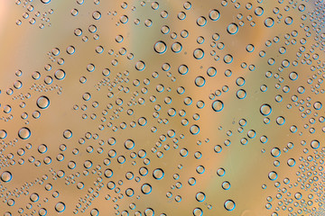Small micro drops of water behind glass