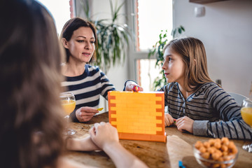 Family playing board games at home