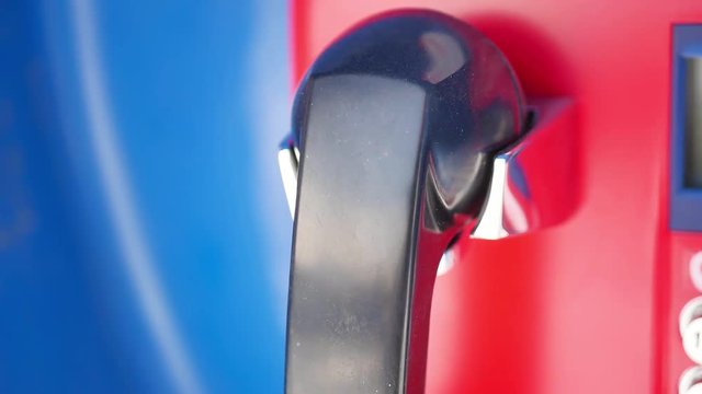 Red payphone booth with blue background.