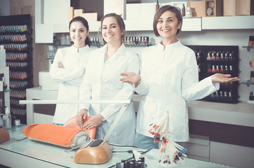 Obraz premium Portrait of professional manicurists at working place inviting to salon