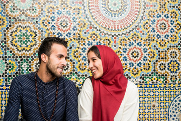 Muslim couple in relationship in front of arabesque oriental decoration
