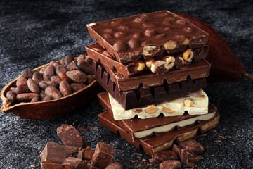 Chocolate bars on dark background with chocolate tower