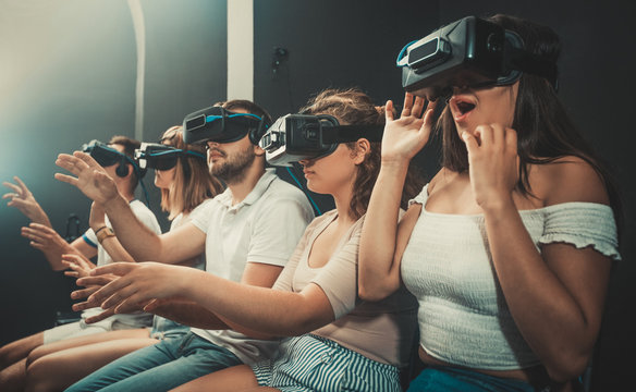  Girl watching exciting movie with VR glasses