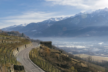 Fototapeta na wymiar Swerving roads in Valtellina, a valley near Sondrio in the Lombardy region of northern Italy, bordering Switzerland
