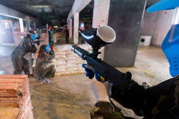 Players are targeting in opponents from cover in battlefield.