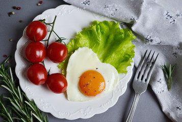 Tasty Fried Egg in the Shape of a Heart Served on a White Plate Rosemary Tomato Salad Leaves Grey Background Valentine Day Morning