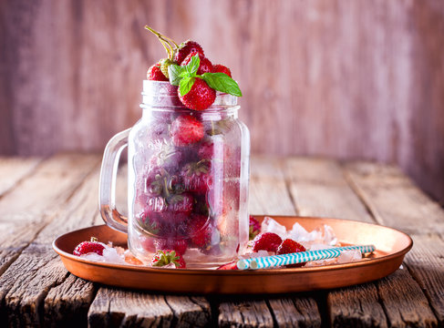 Fresh Strawberries in a glass Jar for Drinks on Vintage wooden background.Food or Healthy diet concept.Vegetarian.Copy space for text. selective focus