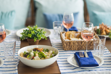 Restaurant table set with glasses, napkins and cutlery