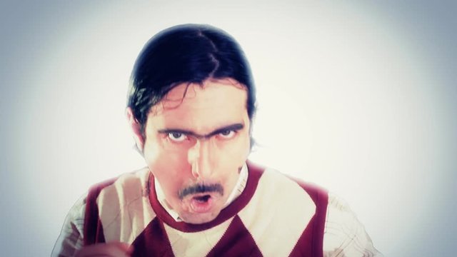 An ugly nerd making dance movements. Everything is white around him. Funny comedy scene. Close-up shot.
