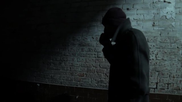 4k Nervous man walks in the doorway from side to side and waiting for meeting with drug-dealer 