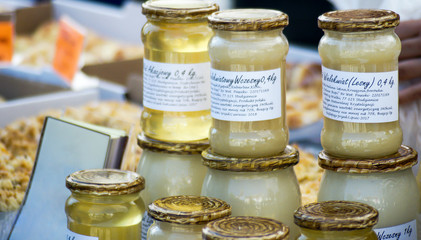honey in jars at the marketplace - obrazy, fototapety, plakaty