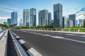 Fototapeta na wymiar empty asphalt road on modern bridge with city skyline background.