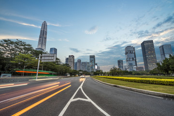 urban city road with motion bus at twilight, china.