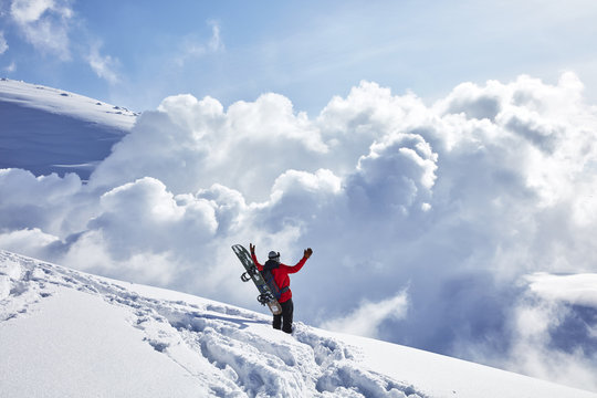 Snowboarder standing on top of mountain