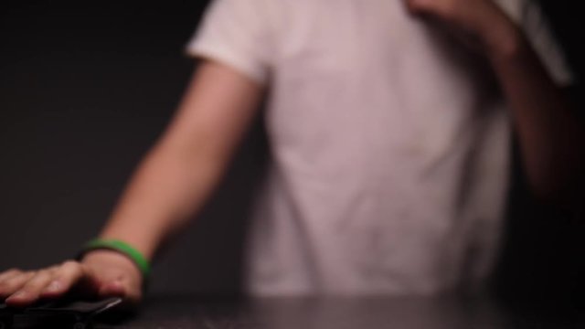 BOY GETTING AIR WITH A FINGER SKATEBOARD, IN SLOW MOTION