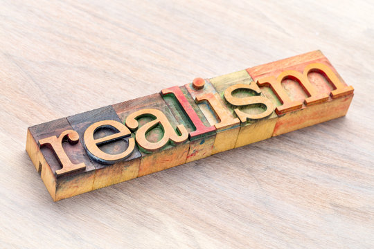 realism word abstract in wood type
