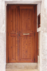 old wooden door, with trim metal ornaments closeup