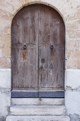 Fototapeta na wymiar old wooden door, with trim metal ornaments closeup