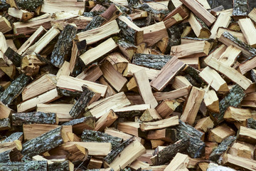 A pile of punctured firewood. Harvested wood for the stove.