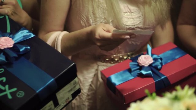 Women hands holding craft gift box. Clip. Young female hands holding gift box with ribbon. Women hold gifts for birthday