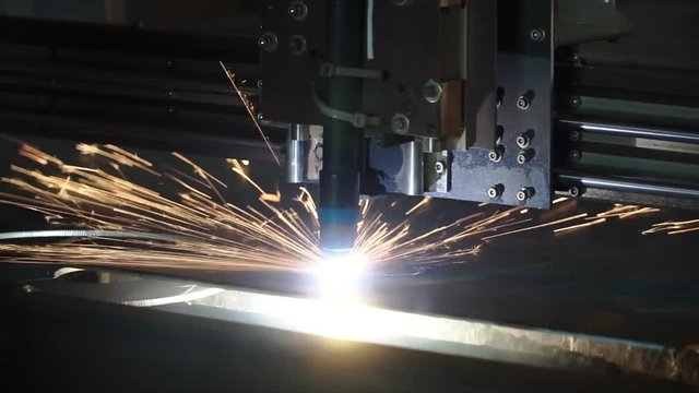 The industrial laser cutting torch cuts preparations from metal. Clip. Laser cutter in the production. Industrial cnc plasma cutting of metal plate
