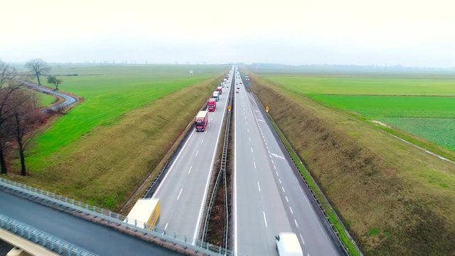 Highway traffic of car and trucks aerial video drone