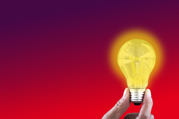 Hand holding a light bulb,concept of adding ideas to work or business,Concepts ideas on a blank background.	