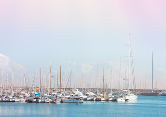 Fototapeta na wymiar Panoramic View of Beautiful Seascape with Luxury Yachts in Harbor. Turquoise Water Pastel Colors Blue Sky Breezy Airy Atmosphere. Urban Lifestyle Photo Maritime Leisure Activity.