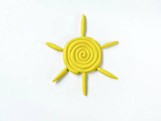 Beautiful sun made from plasticine clay dough on white background