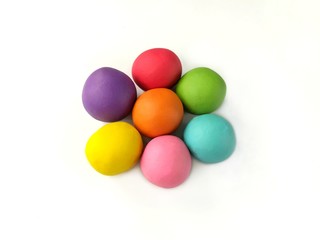 Fototapeta na wymiar Colorful plasticine clay dough made are balls arrange flower shape