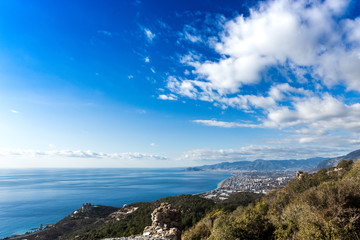 Mediterranean landscape with ruins of ancient town, sea