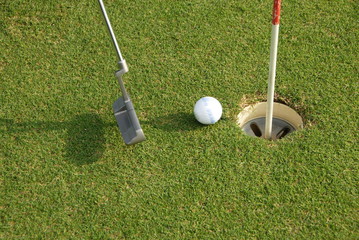 A short put in the game of golf with a ball and a putter
