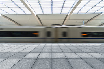 Subway station with train running in blurred motion