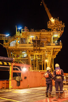 Two Worker In Offshore Oil And Gas Operation Discussion About Platform Before Transfer To Working On Platform In Night Ship During Stand In Supply Boat