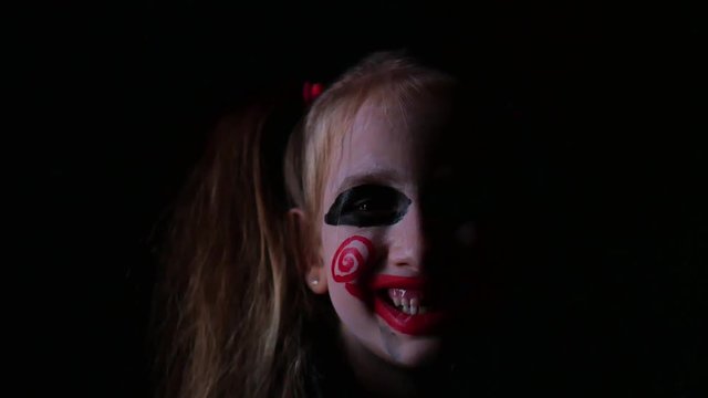 Young girl with film cosplay makeup. Girl with make-up in nightmare style a black background.