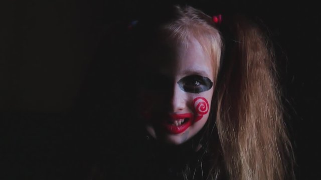 Young girl with film cosplay makeup. Girl with make-up in nightmare style a black background.