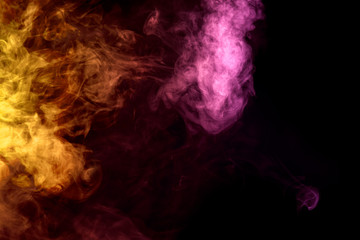 Thick colorful smoke of  orange and pink on a black isolated background. Background from the smoke of vape